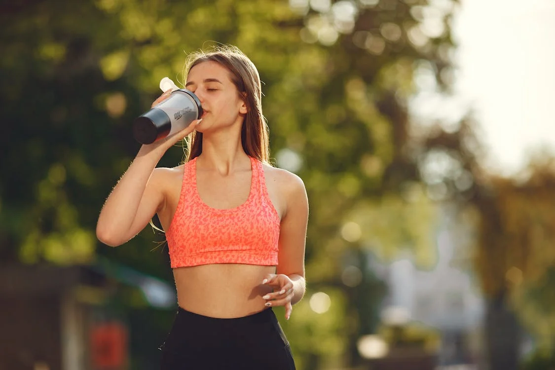 Woman drinking water after workout